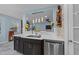 Kitchen features black cabinets, stainless steel appliances, and a pass-through window at 5705 Katha Dr, Holly Springs, NC 27540
