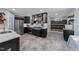 Bright modern kitchen features stainless appliances, white countertops, black cabinets and eat in area at 5705 Katha Dr, Holly Springs, NC 27540