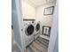 Laundry room features white washer and dryer, with white cabinets for storage at 5705 Katha Dr, Holly Springs, NC 27540