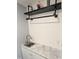 Laundry room features modern sink with marble countertop, white backsplash and industrial style shelf at 5705 Katha Dr, Holly Springs, NC 27540