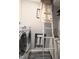 Bright laundry room with modern washer and dryer adjacent to the ladder for utility access at 5705 Katha Dr, Holly Springs, NC 27540