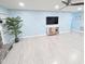 Bright living room with hardwood floors, a stone fireplace, and modern wall accents at 5705 Katha Dr, Holly Springs, NC 27540
