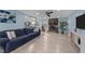 Spacious living room with a stone fireplace, comfortable seating, and ample natural light at 5705 Katha Dr, Holly Springs, NC 27540