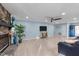 Cozy living room features a stone fireplace, hardwood floors, and a modern entertainment center at 5705 Katha Dr, Holly Springs, NC 27540