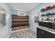 Mudroom boasts built-in bench with storage baskets, shiplap accent wall, and convenient microwave station at 5705 Katha Dr, Holly Springs, NC 27540