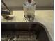 Close-up of a stainless steel sink with running water and white countertop at 5705 Katha Dr, Holly Springs, NC 27540