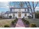 Charming white two-story home with a brick pathway and manicured landscaping at 808 W Willowbrook Dr, Burlington, NC 27215