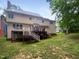 Backyard featuring a wooden deck and a spacious grassy area, perfect for outdoor activities at 113 Crosswind Dr, Cary, NC 27513