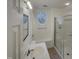 Bright bathroom with a stand-up shower and a vanity with sink, featuring a unique oval window at 113 Crosswind Dr, Cary, NC 27513
