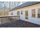 View of the back deck on the home showing the side of the home and door leading to the interior at 309 Monterey Ct, Benson, NC 27504