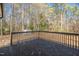 View of the back deck in the backyard showcasing the natural treed surroundings at 309 Monterey Ct, Benson, NC 27504