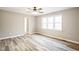 Bedroom featuring a ceiling fan, a triple window and wood-look flooring at 309 Monterey Ct, Benson, NC 27504