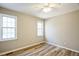 Bedroom featuring two windows, ceiling fan and wood-look flooring at 309 Monterey Ct, Benson, NC 27504