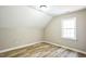 This bedroom features neutral walls, sleek baseboards, a window and modern hardwood floors at 309 Monterey Ct, Benson, NC 27504