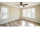 Bedroom featuring two windows, ceiling fan and wood-look flooring at 309 Monterey Ct, Benson, NC 27504