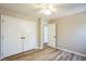Neutral bedroom featuring wood floors, a ceiling fan, and a closet at 309 Monterey Ct, Benson, NC 27504