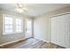 Neutral bedroom featuring wood floors, a ceiling fan, and access to the backyard at 309 Monterey Ct, Benson, NC 27504