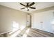 Neutral bedroom featuring hardwood floors, a ceiling fan, and a closet at 309 Monterey Ct, Benson, NC 27504