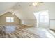 Spacious bonus room with vaulted ceilings, ceiling fans, large windows and sleek modern flooring at 309 Monterey Ct, Benson, NC 27504