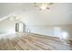 Spacious bonus room with vaulted ceilings, ceiling fans, large windows and sleek modern flooring at 309 Monterey Ct, Benson, NC 27504