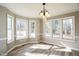 Sunlit dining area with hardwood floors, large windows, and an elegant chandelier at 309 Monterey Ct, Benson, NC 27504