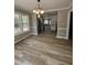 Open concept dining room with hardwood floors leading to a kitchen with stainless steel appliances at 309 Monterey Ct, Benson, NC 27504