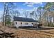Exterior view of the back of the home showing the yard and treed surroundings at 309 Monterey Ct, Benson, NC 27504