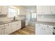 Bright kitchen with granite countertops, stainless steel appliances, and white cabinets at 309 Monterey Ct, Benson, NC 27504