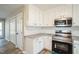 Bright kitchen with granite countertops, stainless steel appliances, and white cabinets at 309 Monterey Ct, Benson, NC 27504