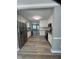 Spacious kitchen with white cabinets, granite countertops and stainless steel appliances open to dining room at 309 Monterey Ct, Benson, NC 27504