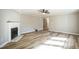 Spacious living room with fireplace, hardwood flooring, neutral walls, and a ceiling fan at 309 Monterey Ct, Benson, NC 27504
