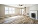Bright living room featuring wood floors, a fireplace, and a staircase to the second floor at 309 Monterey Ct, Benson, NC 27504