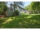 The lush backyard features a deck with shade, inviting relaxation and entertainment within a private, verdant setting at 340 Andrews Store Rd, Pittsboro, NC 27312