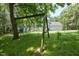 The spacious backyard showcases a large tree with swings, enhancing the property's appeal for Gathering fun and outdoor enjoyment at 340 Andrews Store Rd, Pittsboro, NC 27312