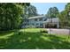 A well-maintained backyard features a spacious lawn, garage, and deck, ideal for outdoor enjoyment and entertainment at 340 Andrews Store Rd, Pittsboro, NC 27312