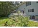 Expansive deck with stairs descends into a meticulously landscaped backyard, blending outdoor living with serene natural beauty at 340 Andrews Store Rd, Pittsboro, NC 27312