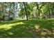 Expansive backyard featuring lush greenery and a charming wooden swing set at 340 Andrews Store Rd, Pittsboro, NC 27312