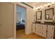 Bathroom features a double vanity, tile floors, and a peek into the bedroom at 340 Andrews Store Rd, Pittsboro, NC 27312