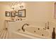 Bathroom featuring a soaking tub, double vanity, and white tiled walls at 340 Andrews Store Rd, Pittsboro, NC 27312