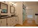 Bright bathroom with a double vanity, granite countertops, a glass enclosed shower, and washer and dryer hookups at 340 Andrews Store Rd, Pittsboro, NC 27312