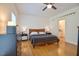 Well-lit bedroom with a ceiling fan, hardwood floors, and stylish furnishings at 340 Andrews Store Rd, Pittsboro, NC 27312