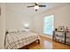 Bedroom featuring a window letting in natural light and a bed with a checkered pattern comforter at 340 Andrews Store Rd, Pittsboro, NC 27312