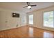 Light-filled bedroom features hardwood floors, modern fixtures, a ceiling fan, and white-painted trim at 340 Andrews Store Rd, Pittsboro, NC 27312