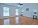 Spacious bedroom with hardwood floors, natural light from multiple windows, and modern fixtures at 340 Andrews Store Rd, Pittsboro, NC 27312