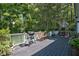 Spacious deck with a grill and outdoor seating, perfect for entertaining and enjoying the wooded backyard at 340 Andrews Store Rd, Pittsboro, NC 27312
