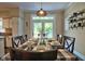 Kitchen dining area with table set for six and access to back deck at 340 Andrews Store Rd, Pittsboro, NC 27312