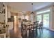 Bright and airy dining room with a checkered tablecloth and access to the kitchen at 340 Andrews Store Rd, Pittsboro, NC 27312