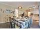 Bright dining room with black tile floors, a modern chandelier, and access to the open kitchen at 340 Andrews Store Rd, Pittsboro, NC 27312