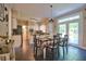 Charming dining room with black tile floors, modern lighting, and a view of the outdoor patio at 340 Andrews Store Rd, Pittsboro, NC 27312