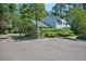 View of the exterior elevation of the house with lush landscaping, and a driveway showcasing the property's curb appeal at 340 Andrews Store Rd, Pittsboro, NC 27312